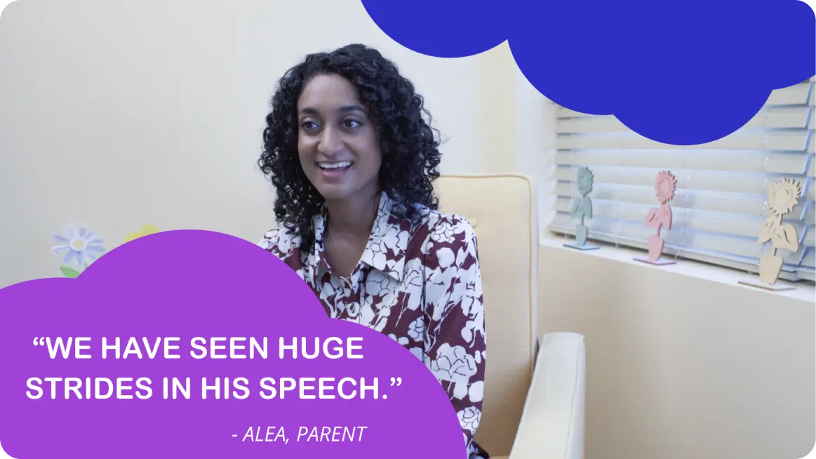 The image shows a person sitting in front of a blue screen background, with text overlaying the image that reads 'we have seen huge strides in his speech.